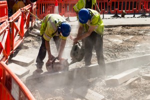 Two Builders Cutting Concrete Wet Cutting - Emigrate2