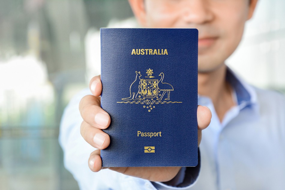 A man showing passport (of Australia) - Emigrate2